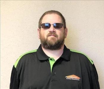 a male with brown hair and beard headshot wearing servpro ready uniform