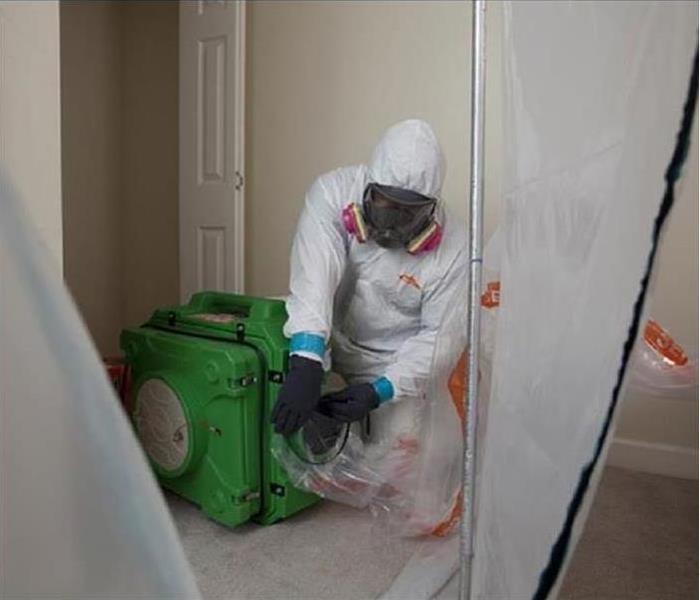 A SERVPRO of Dane County West Production Technician in a Bio-hazard suit for safety to remove bio-hazardous material 