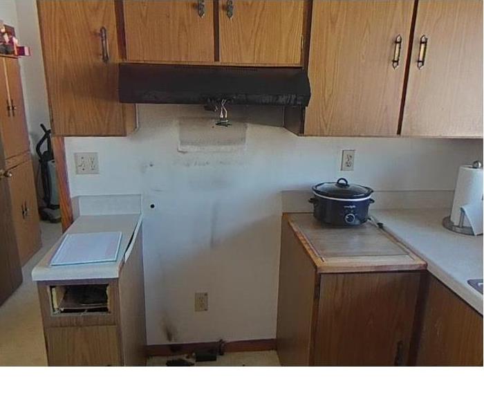 a kitchen with fire damage from a stove 