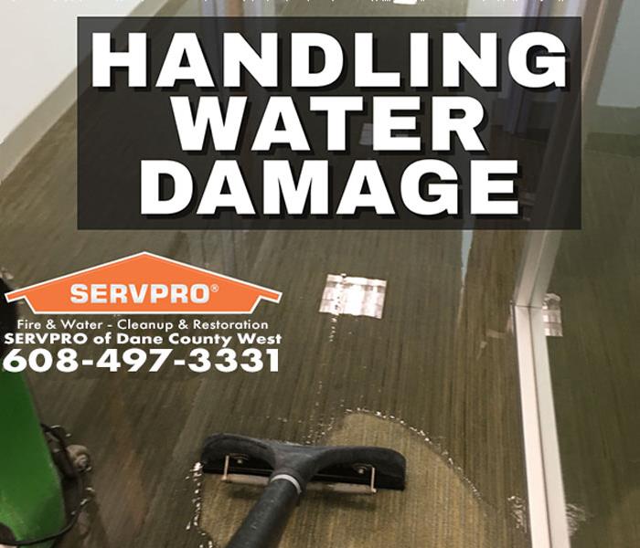 a flooded bathroom with a SERVPRO machine extracting water in Madison, Wisconsin