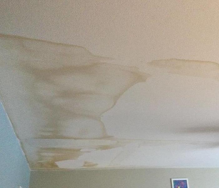 a ceiling with brown water stains 