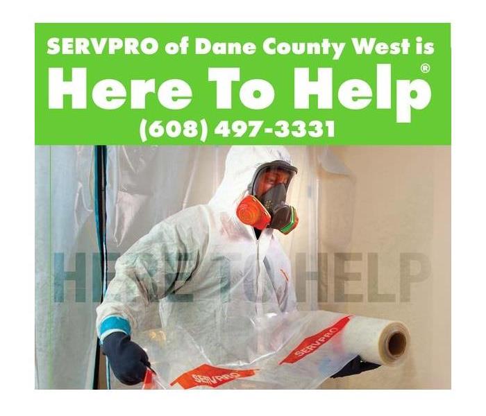 A servpro technician in hazmat attire with title reading "SERVPRO is Here to Help"