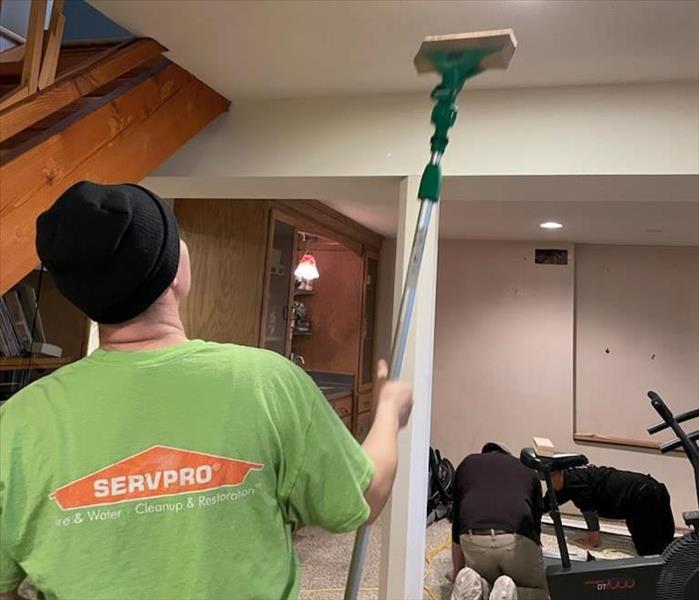 servpro of dane county west technician in servpro tshirt cleaning soot with chem sponge