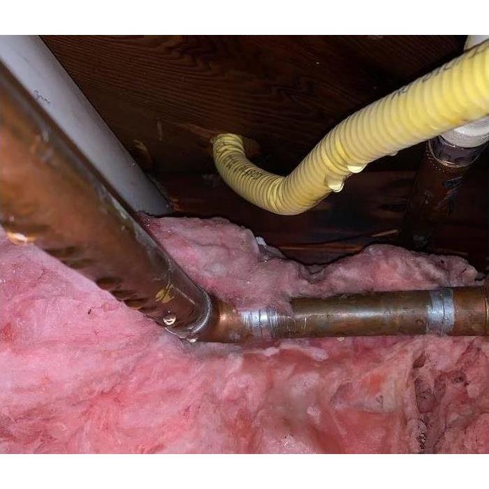 broken water pipes under a kitchen sink