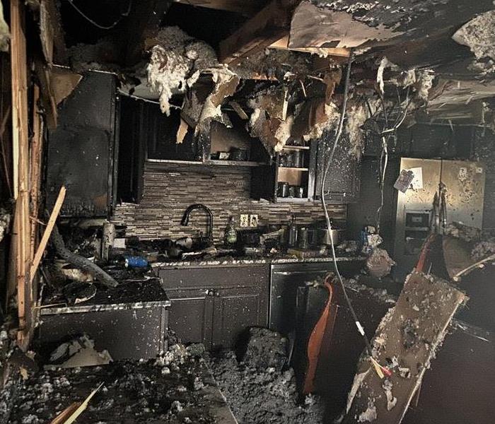 a blackened and charred smoke damaged kitchen after a cooking fire ravaged the interior 