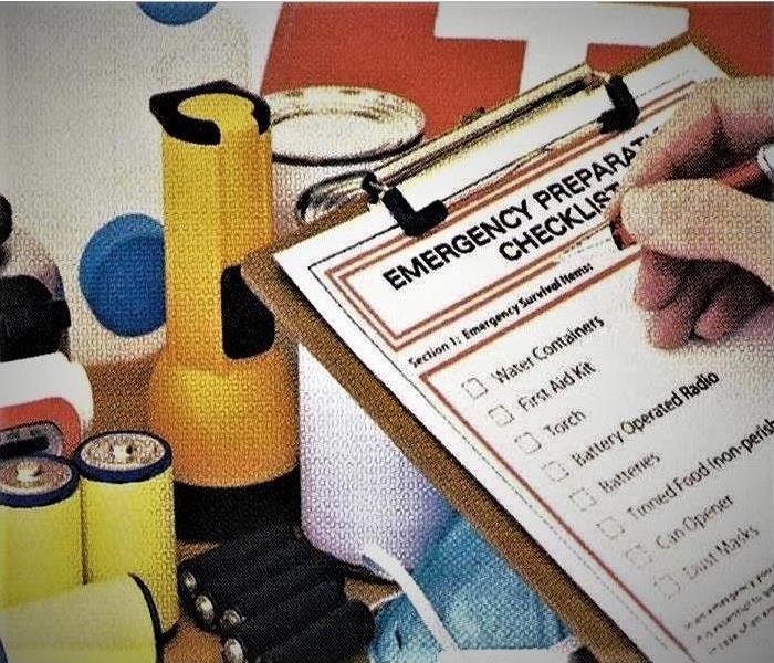 a clip board with an emergency checklist being checked off by a human hand