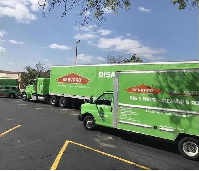 Two SERVPRO disaster recovery green trucks with sky blue background 