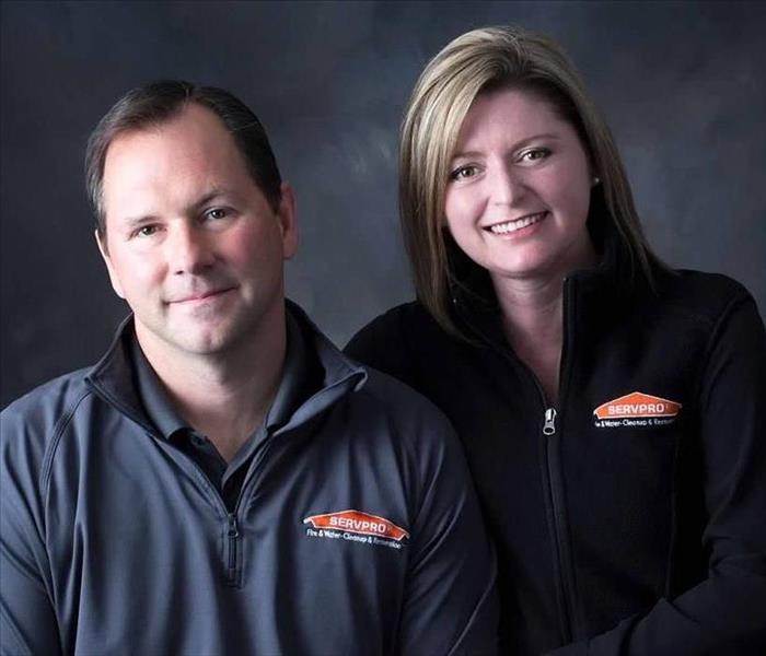 head shots of a owners, Jim and Heather McEllistrem, SERVPRO of Dane County West - they are wearing SERVPRO shirts