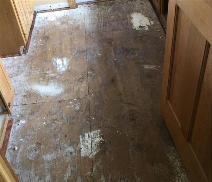 a bathroom with subfloor exposed after water damage 